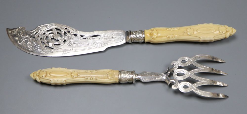 A pair of Victorian carved ivory handled silver fish servers, John Round, Sheffield, 1856, knife, 33.6cm, gross 9.5oz.